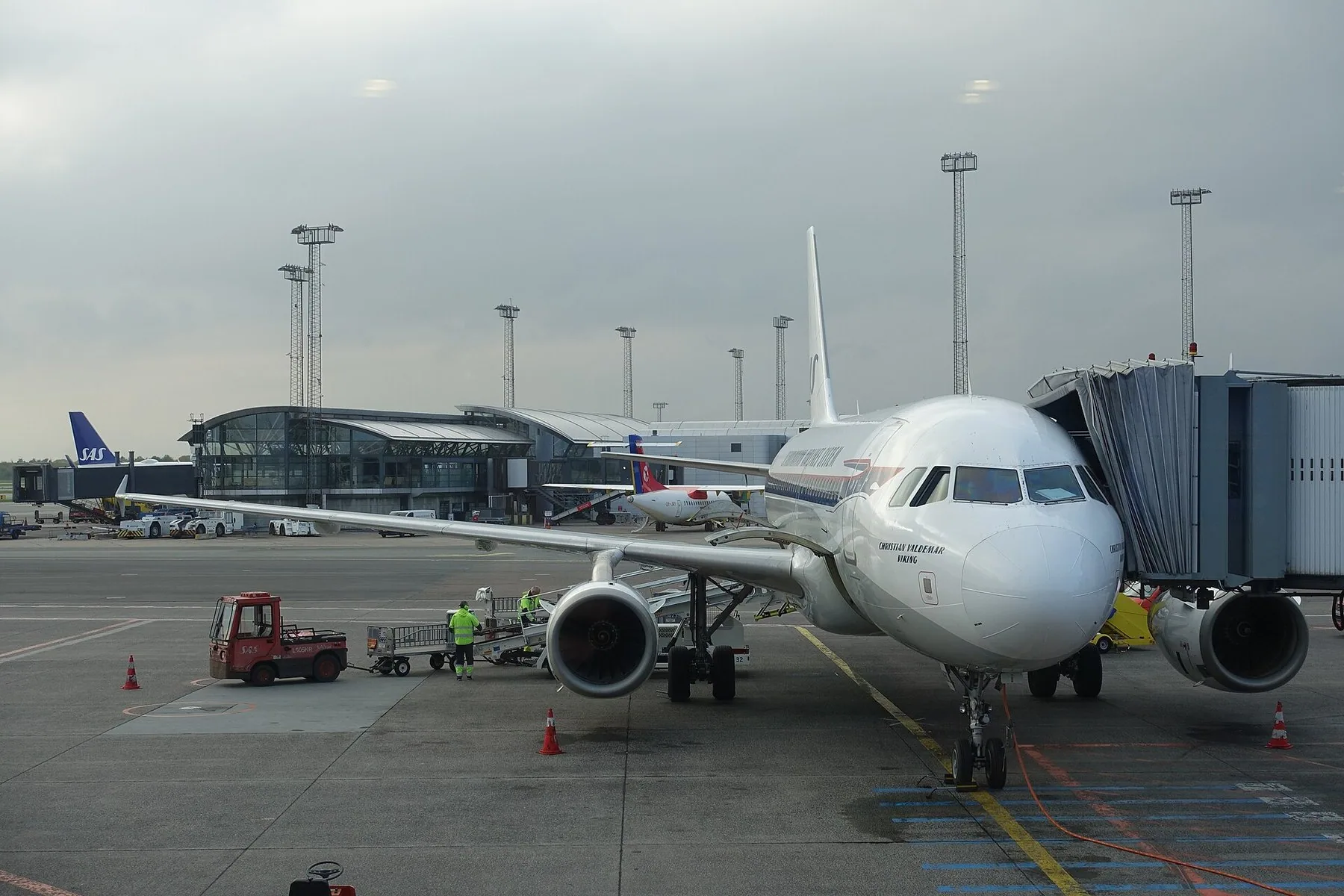 Et fly ved gaten i Københavns Lufthavn i Kastrup, med terminalbygningen i baggrunden